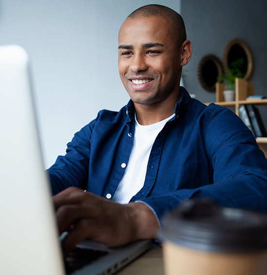 Man sits at desk on computer