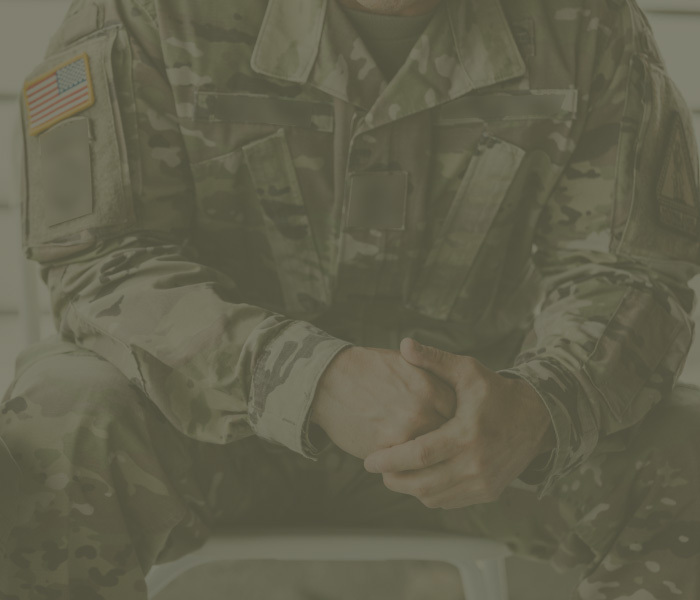 Army National Guard member sits in uniform